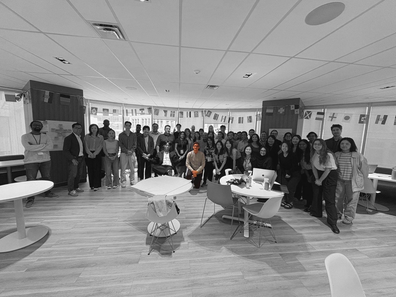 The Air Canada design team gathered in an office, photographed in black and white with one person in colour