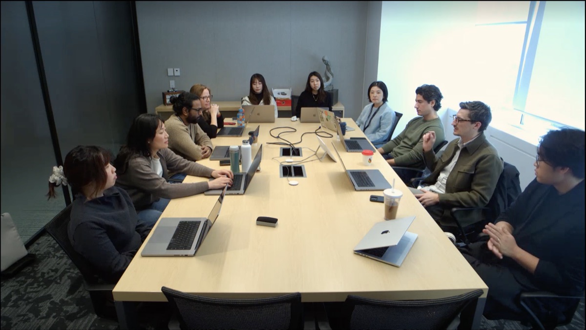 Designers seated around a conference table during a Monthly Design Club session