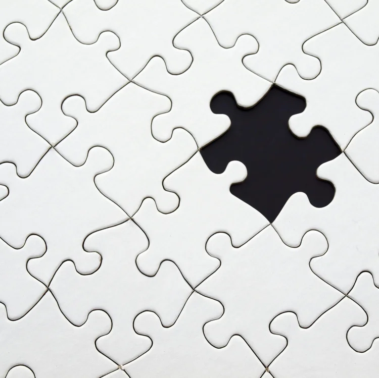 White jigsaw puzzle with one piece missing