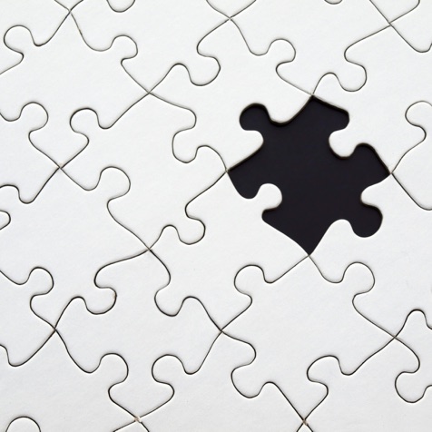 White jigsaw puzzle with one piece missing